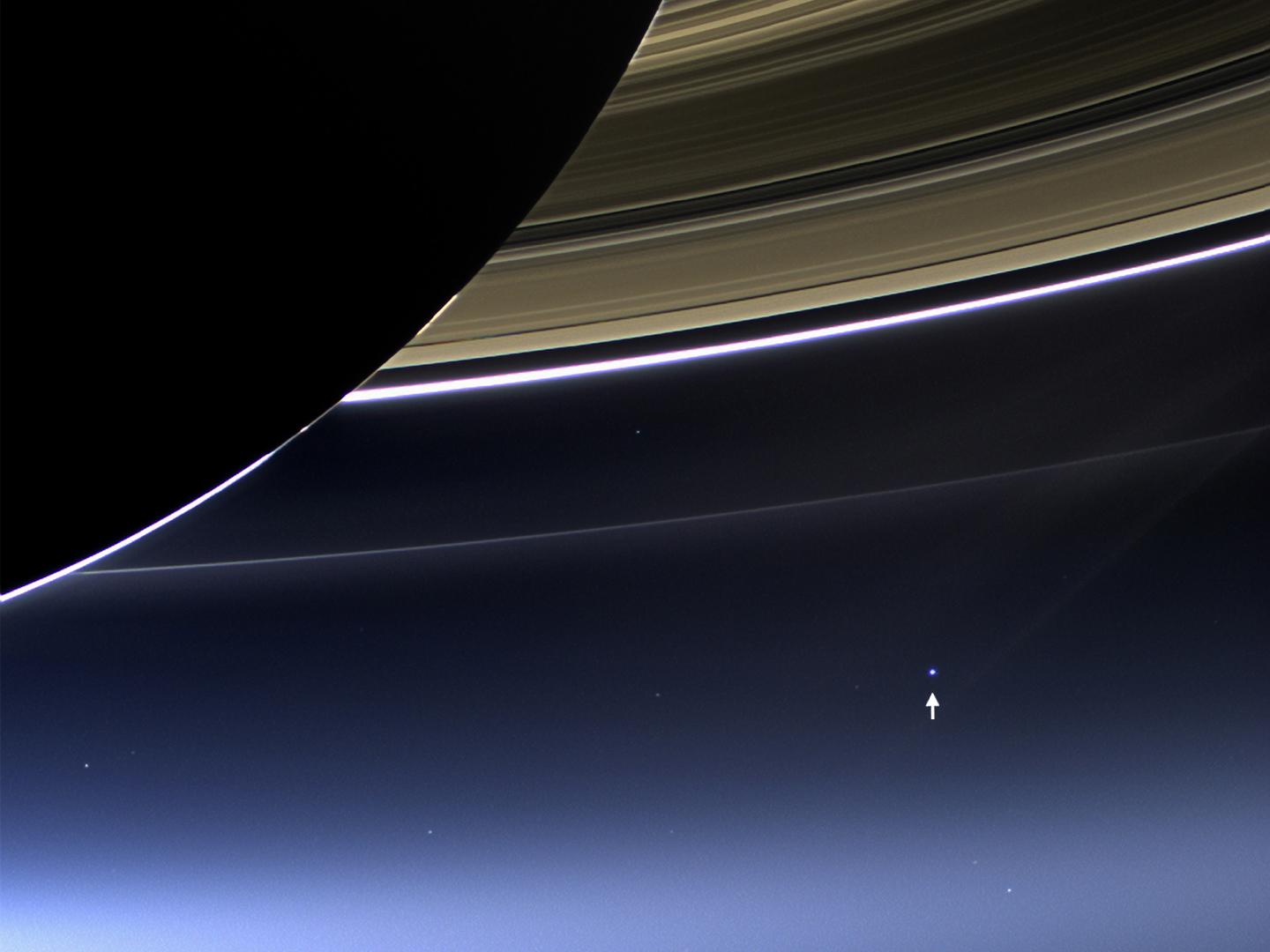 An image from Saturn showing a minuscule planet Earth in the distance
